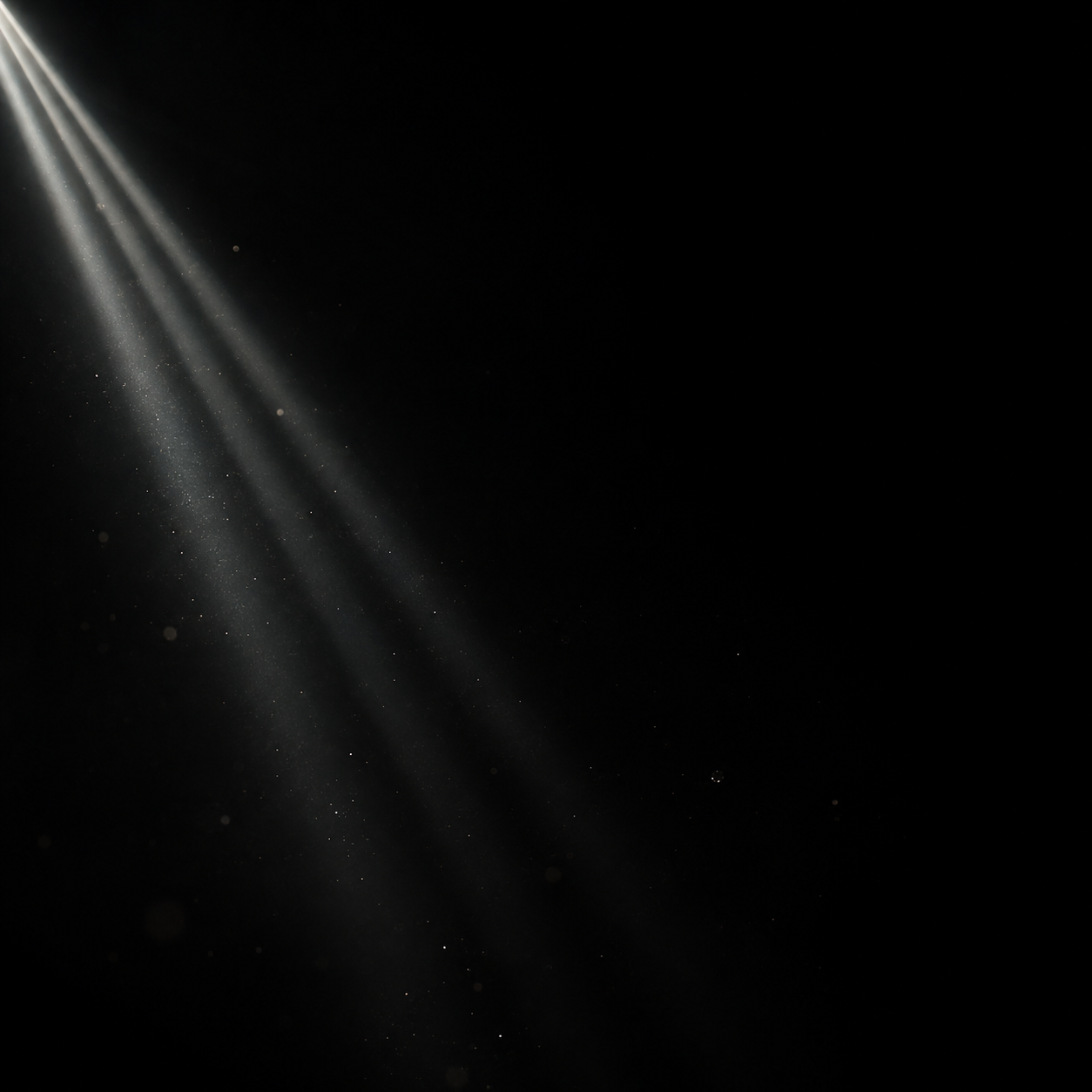 Three very narrow parallel white light rays enter from the upper left, fade quickly into black, sparse tiny drifting dust.