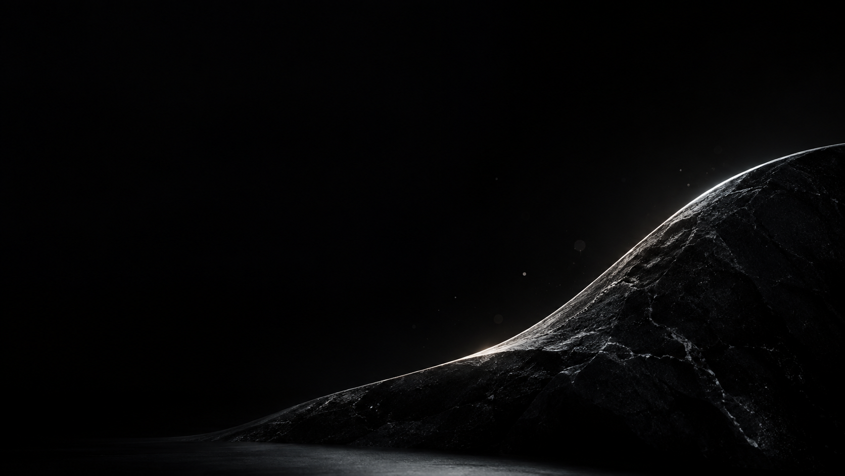 A black sculptural stone curve at the bottom is outlined by one cool white rim light, a handful of microscopic glints.