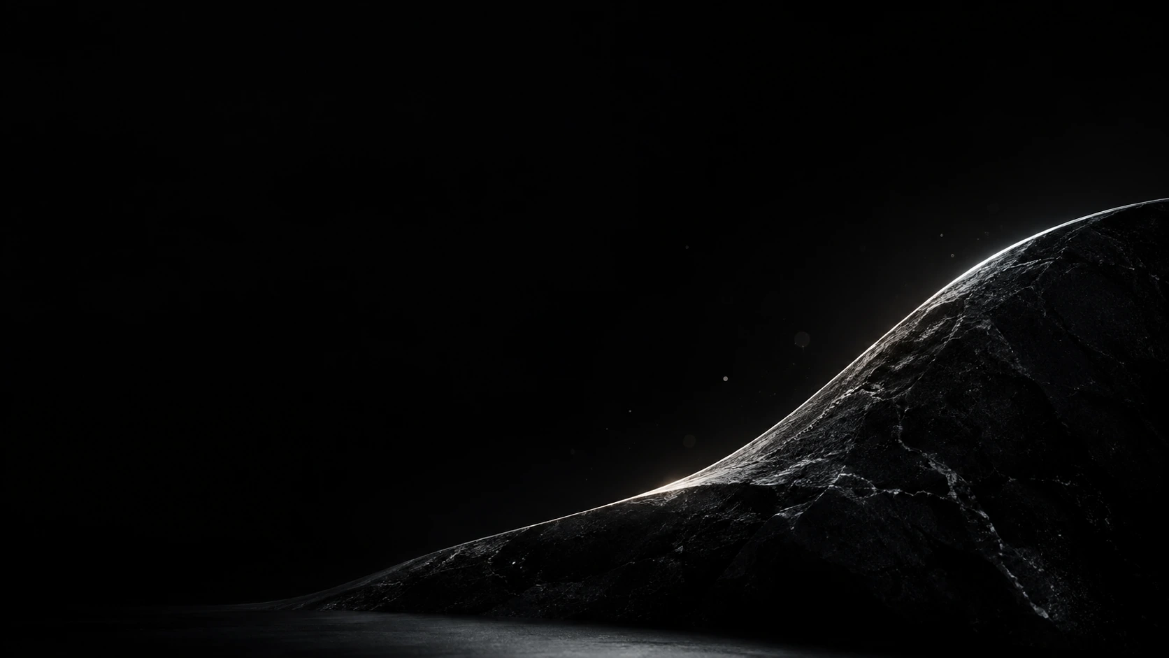 A black sculptural stone curve at the bottom is outlined by one cool white rim light, a handful of microscopic glints.