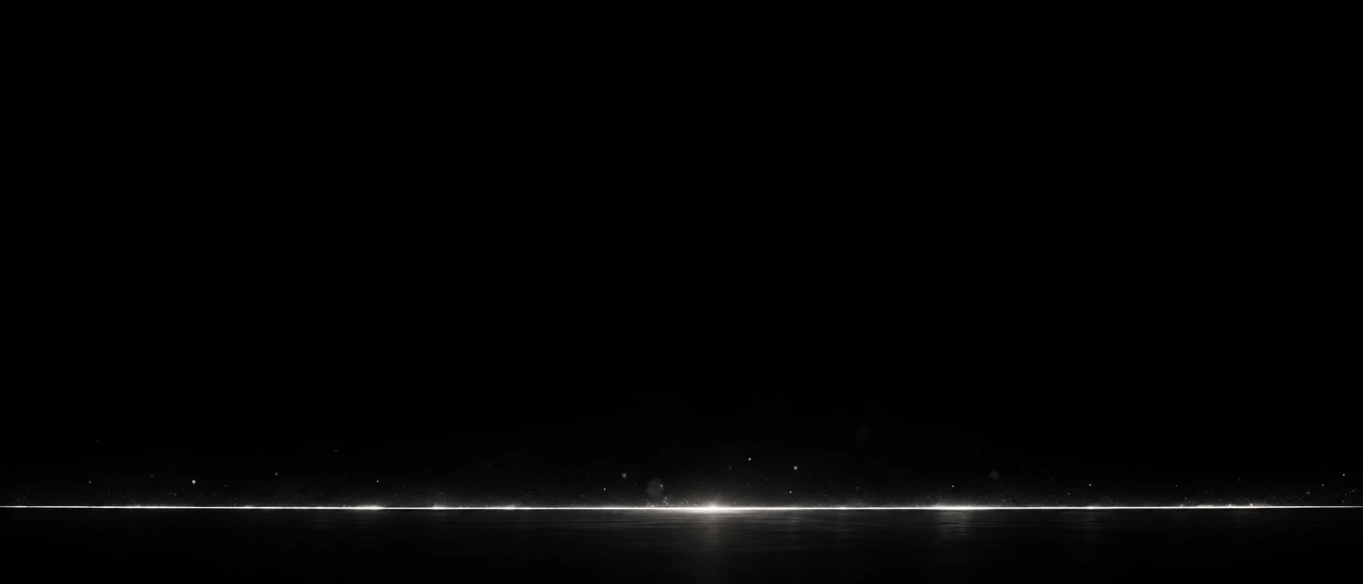 A panoramic nearly black image with one long extremely fine white slit near the bottom, a few tiny silver sparkles just above it.