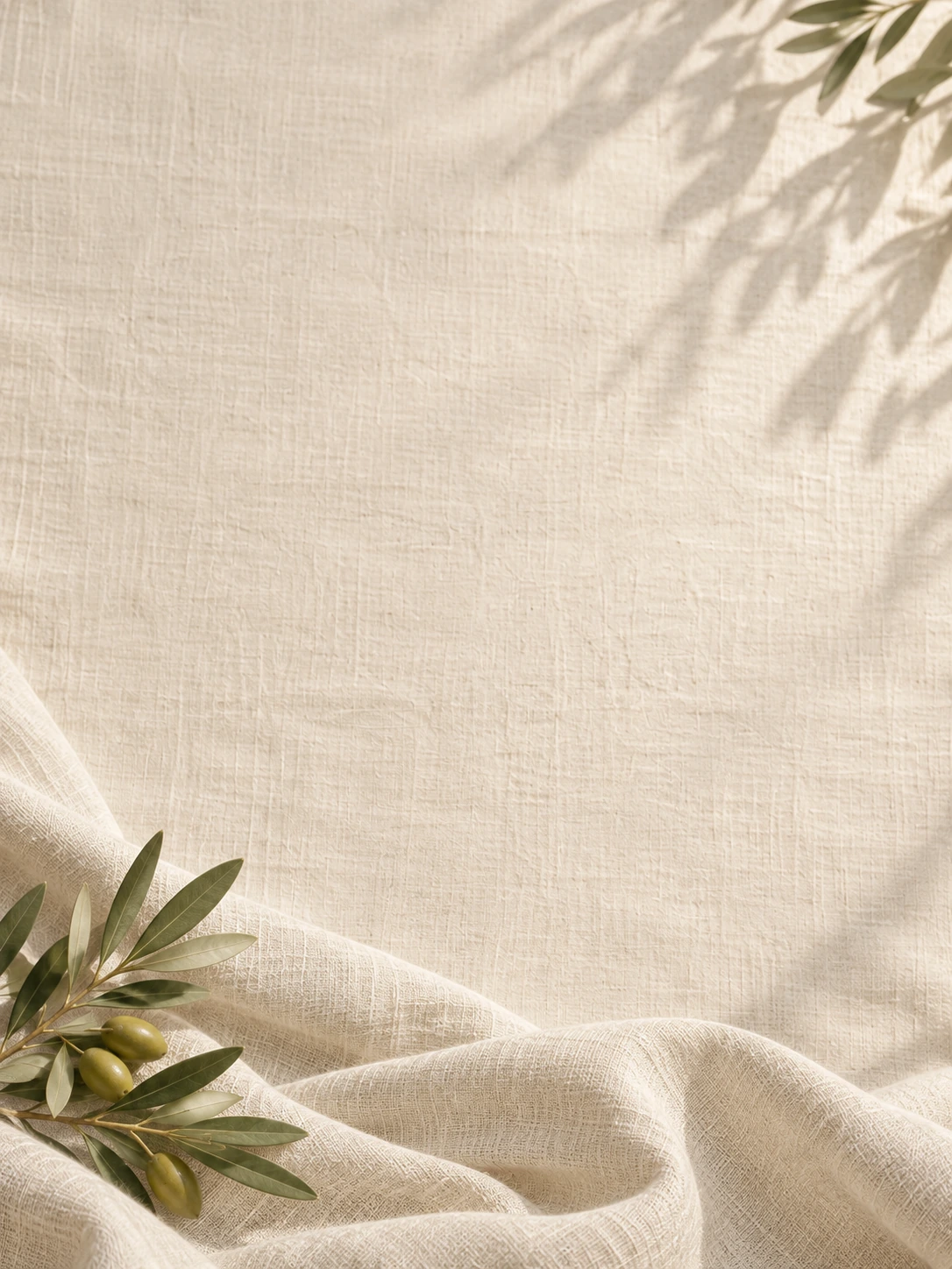 Soft linen folds and gentle olive morning light. Mobile hero background.