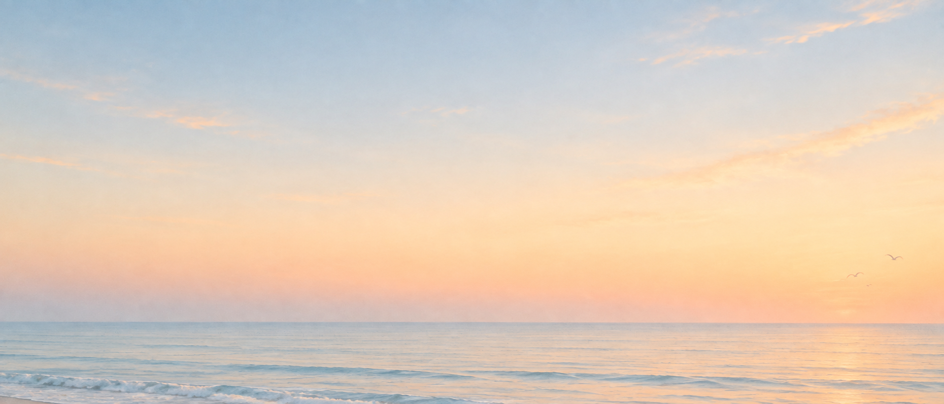 An open horizon in gentle peach-colored light. Low-detail section background or divider.