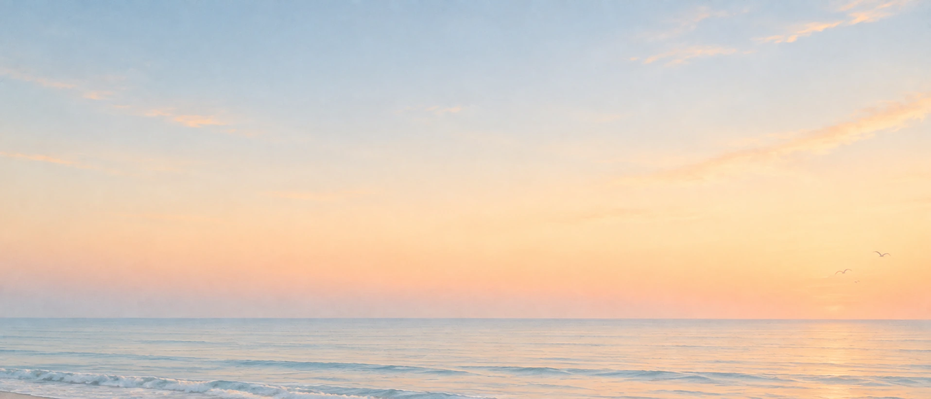 An open horizon in gentle peach-colored light. Low-detail section background or divider.